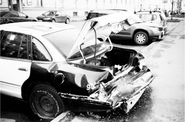crashed car with open trunk